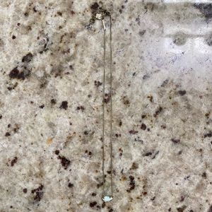 Gold Kendra Scott necklace with white charm